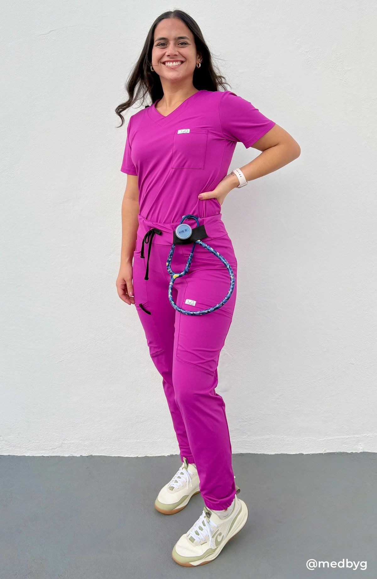 Magenta scrubs nurse with stethoscope hip clip